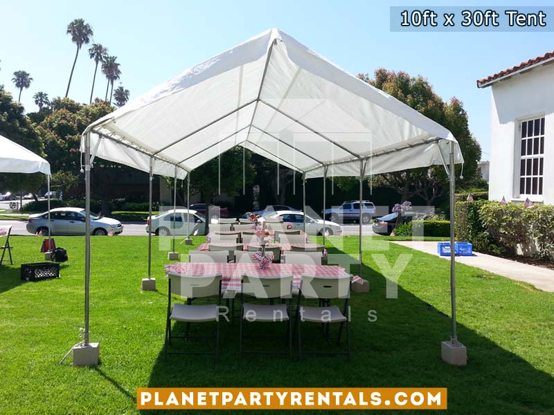 10ft x 30ft Party Tent shown with rectangular tables and plastic white chairs